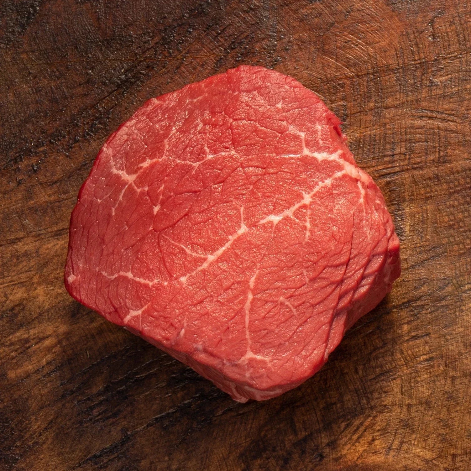 uncooked top sirloin steak with marbling