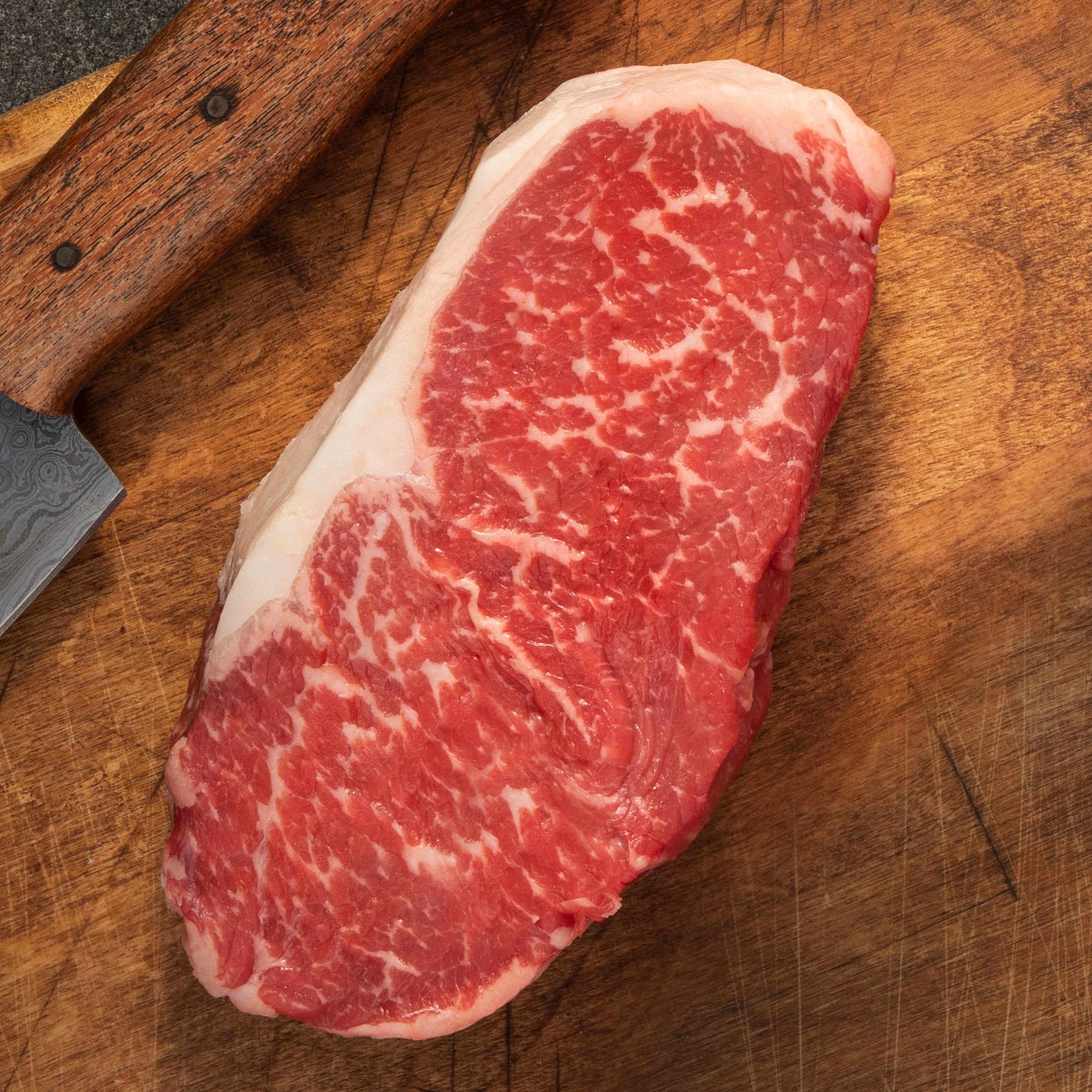 USDA Choice Black Angus New York Strip Steak from 44 Farms with rich marbling and bold beef flavor, ready for grilling or cast iron cooking
