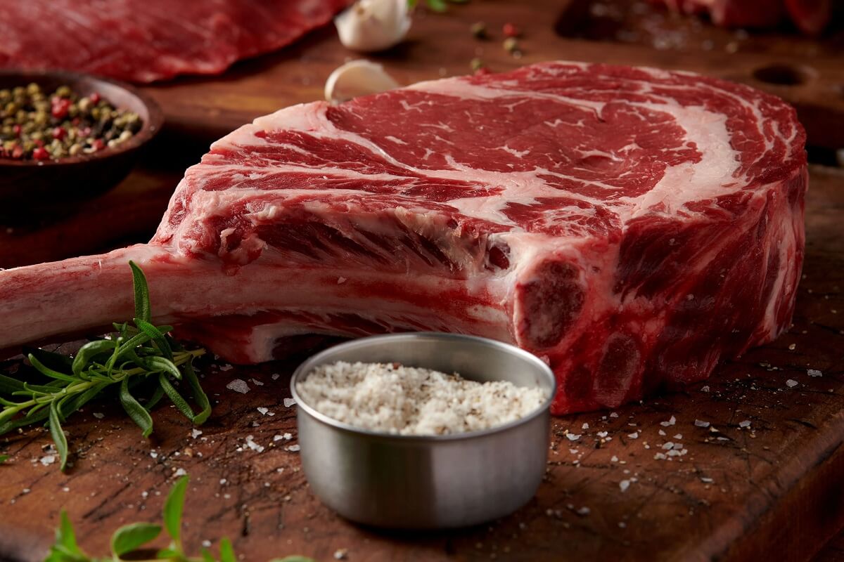 44 Farms USDA Choice Tomahawk Ribeye steak with a full Frenched rib bone, showing the dramatic presentation that makes it a showstopper cut