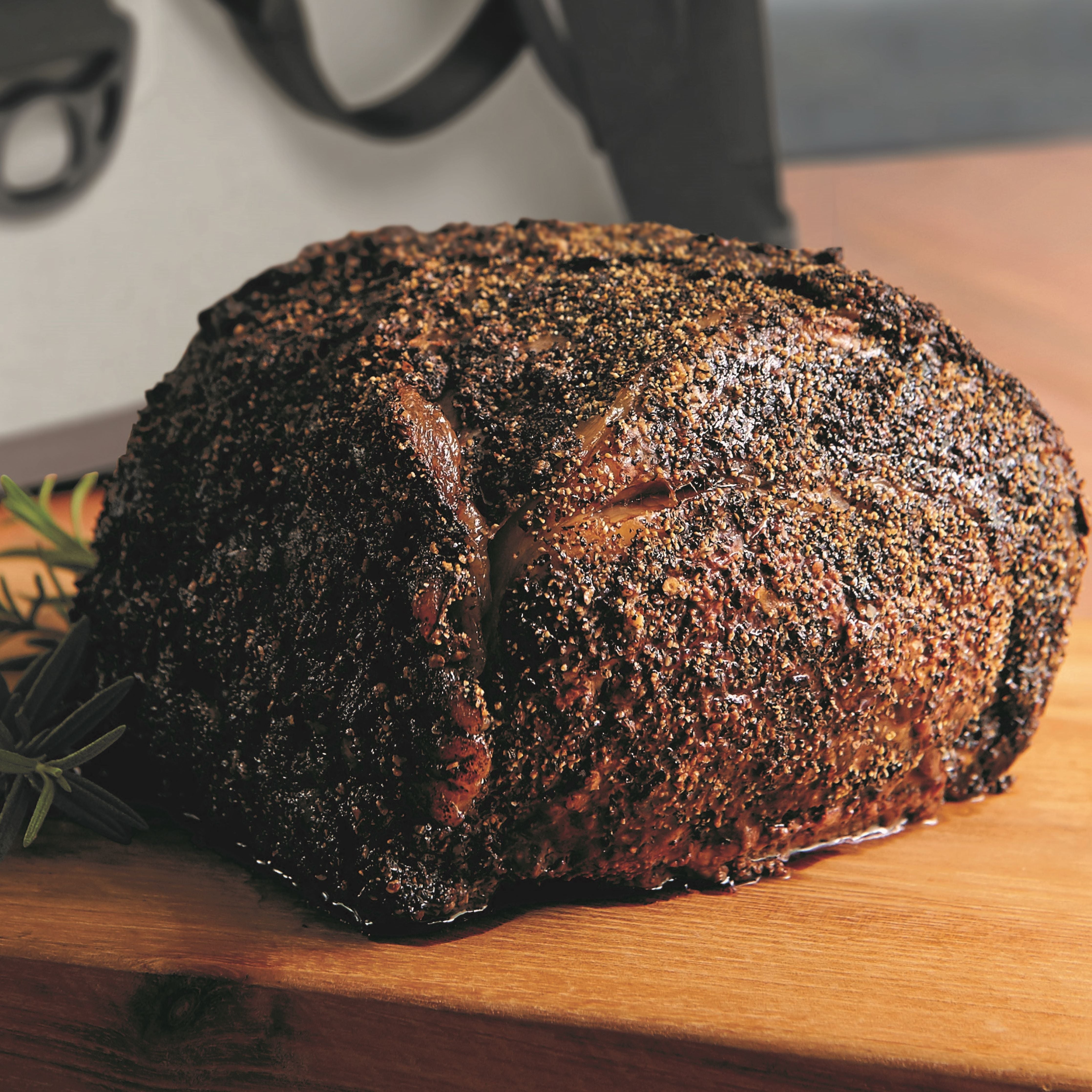 Fully cooked smoked prime rib roast on a cutting board